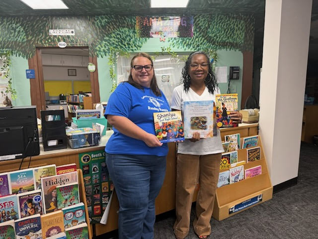 Mary Clark Elliott at a library event with an educator